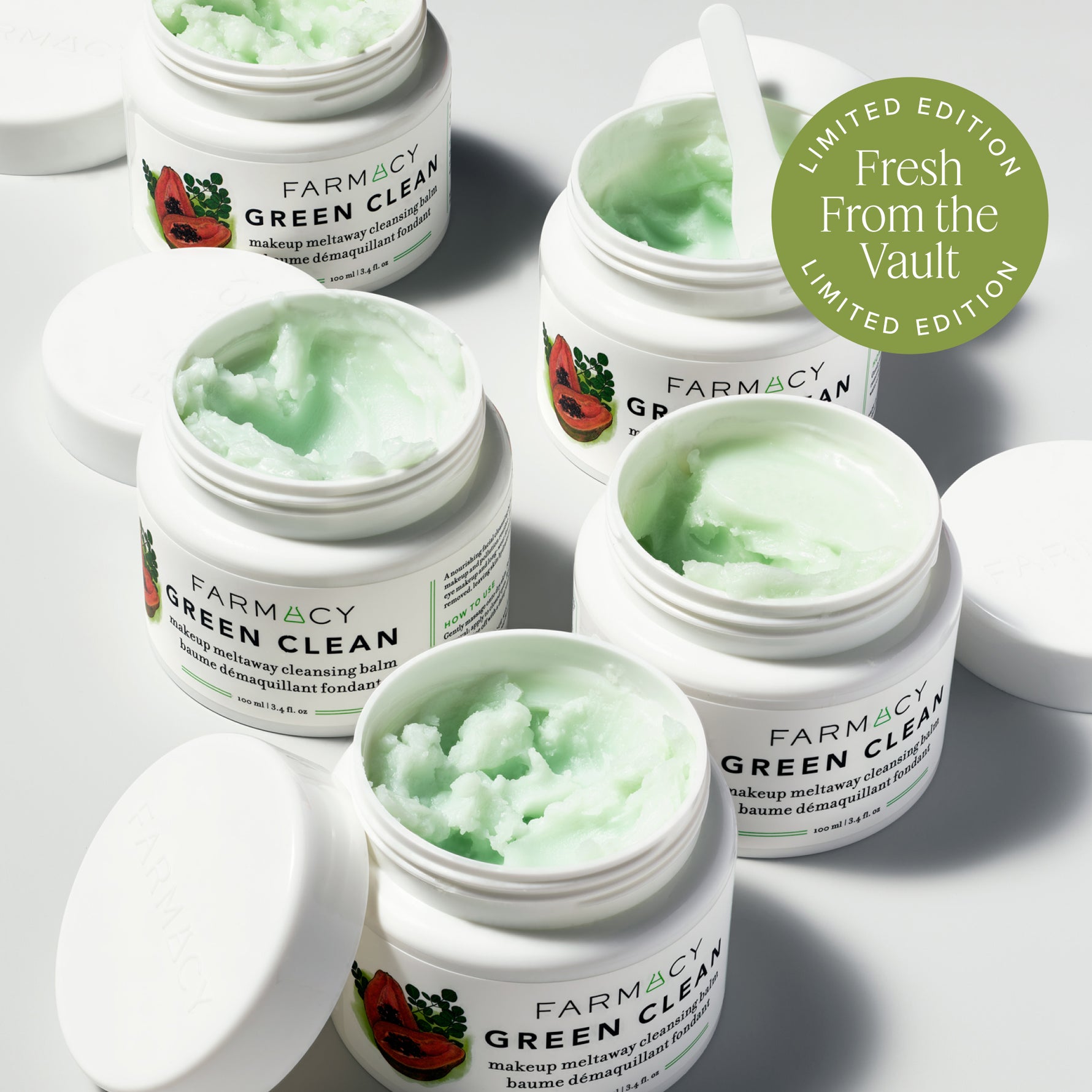 Farmacy Green Clean jars with green scrub on a light gray background