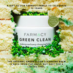 Farmacy Green Clean makeup meltaway cleansing balm surrounded by a decorative cake on a beige background to celebrate the brand anniversary 