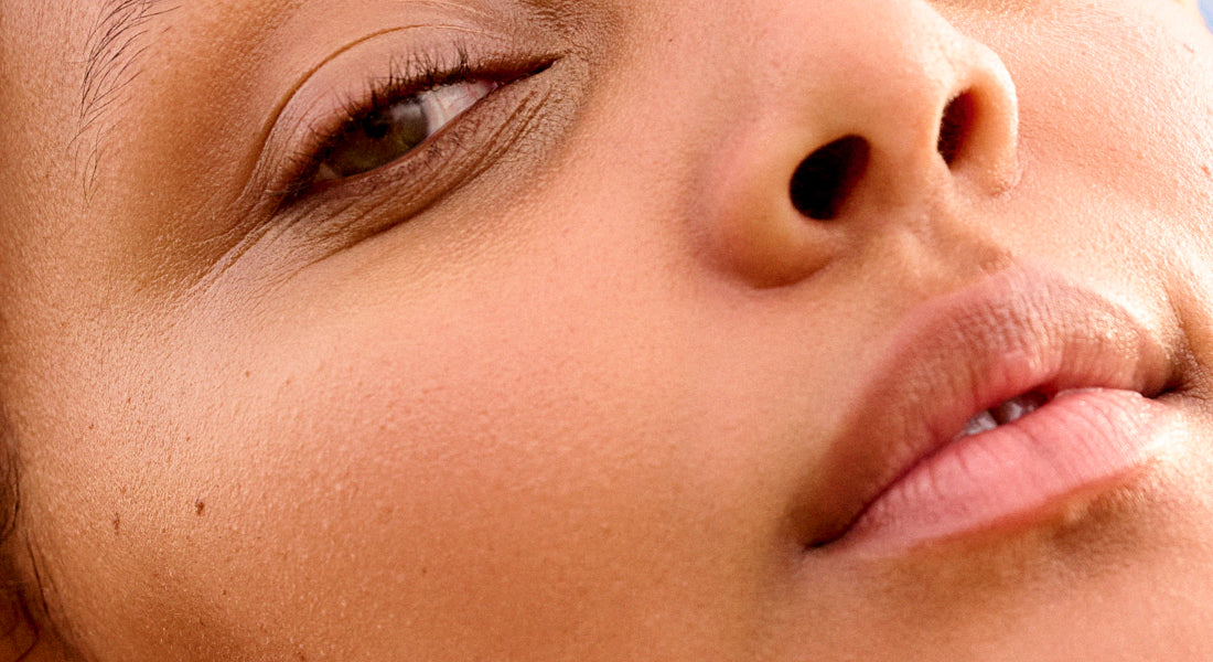Close-up of a model's face with a focus on the eye and nose.