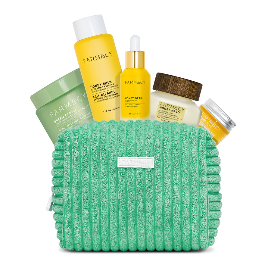 Collection of Farmacy skincare products including bottles and a green pouch on a white background