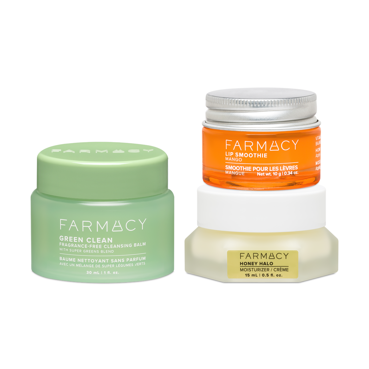 Farmacy Cleanse Comfort Trio featuring a 30 mL jar of Green Clean Fragrance-Free Cleansing Balm, a 10 g jar of Mango Lip Smoothie, and a 15 mL jar of Honey Halo Moisturizer on a white background