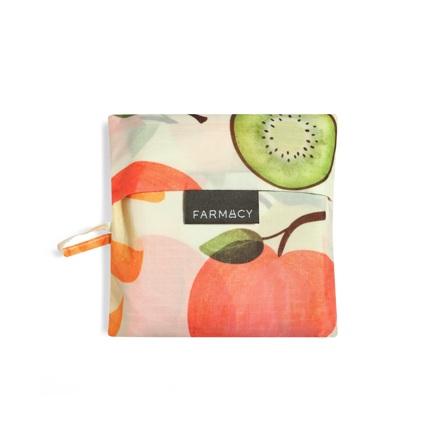 A folded reusable Farmacy x Baggu reusable shopping bag with a watercolor-style fruit print featuring oranges, apples, pears, and kiwi slices on a white background