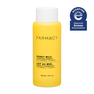 Yellow bottle of Farmacy Honey Milk Hydrating Essence on a white background with National Eczema Association acceptance badge