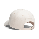 A light beige baseball cap shown from a rear three-quarter angle on a white background, featuring the word 'FARMACY' embroidered on the side and an adjustable strap at the back
