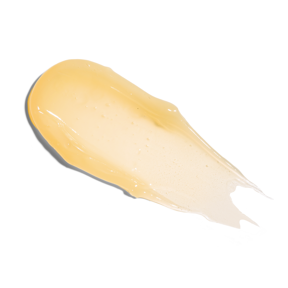 A smear of Farmacy Beauty Honey Vanilla Lip Smoothie on white background