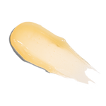 A smear of Farmacy Beauty Honey Vanilla Lip Smoothie on white background