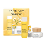 Farmacy Milk + Honey Trio skincare set including a 50mL Honey Milk Essence bottle, 50mL Honey Cloud moisturizer, Honey Butter Lip Balm and matching box on a white background.