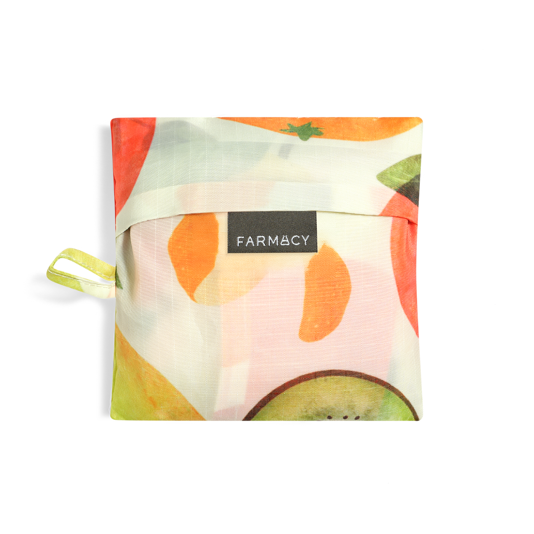 A folded reusable Farmacy x Baggu reusable shopping bag with a watercolor-style fruit print featuring oranges, apples, pears, and kiwi slices on a white background