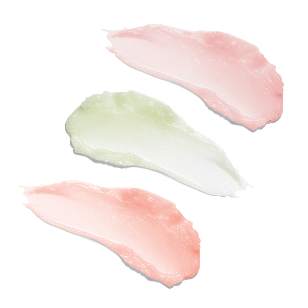 Three Green Clean Cleansing balm swatches on a white background: two soft pink swatches and one pale mint green swatch.