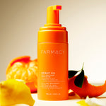 A bottle of Farmacy Beauty Bright On Foam Exfoliator on a light background