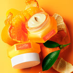 Two eye cream orange jars on an orange background