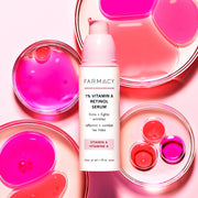 1% Vitamin A Retinol Serum packaging in its cylinder container with the cap off in front of pink colored petri dishes